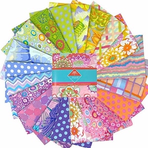 May include: A selection of patterned fabric squares arranged in a circular display. The fabrics showcase floral, polka dot, and geometric patterns in pink, green, blue, and orange hues. A teal band with text is visible in the center.