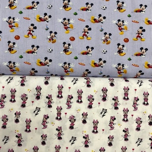May include: Two fabric swatches with different patterns. The top swatch is blue and white with a repeating pattern of Mickey Mouse in various poses. The bottom swatch is white with a repeating pattern of Minnie Mouse in various poses.