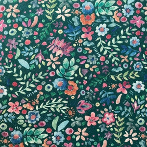 May include: A teal fabric with a repeating pattern of colorful flowers and leaves. The flowers are in shades of pink, red, blue, and yellow. The leaves are green and white.
