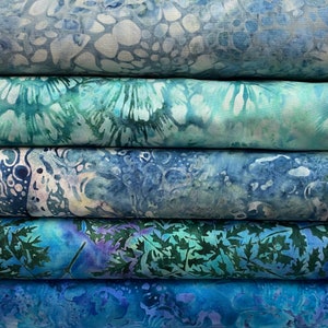 May include: Five fabric swatches in shades of blue and green with various patterns. The top swatch has a light blue background with white and grey spots. The second swatch has a light blue and green background with a swirling pattern. The third swatch has a dark blue background with white and grey spots. The fourth swatch has a light blue background with a dark green leaf pattern. The bottom swatch has a dark blue background with a swirling pattern.