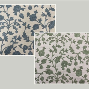 May include: Two fabric swatches with a white background and a floral pattern. The top swatch has a blue floral pattern and the bottom swatch has a green floral pattern.
