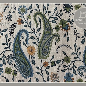 May include: A beige fabric with a paisley pattern in shades of blue, green, and orange. The fabric has a subtle linen texture. The text "FRANK THOMAS INTERIORS" is visible in the top right corner of the image.