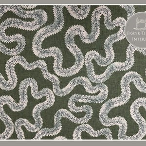 May include: A green fabric with a white and grey pattern of wavy lines. The pattern resembles a series of interconnected branches. The fabric is textured and has a subtle sheen. The text "FRANK THOMAS INTERIORS" is visible in the top right corner of the image.