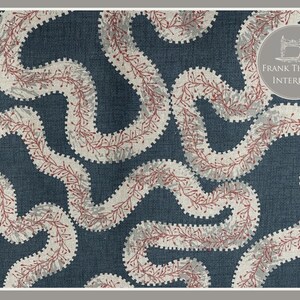May include: A blue fabric with a white and red patterned design of wavy lines. The fabric has a textured look and feel. The text "FRANK THOMAS INTERIORS" is in the top right corner of the image.
