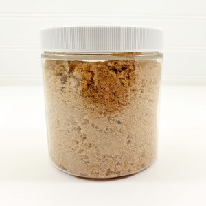 May include: A clear glass jar with a white lid filled with brown sugar.