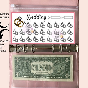 May include: Printable wedding planner tracker with 25 rings to color in as you save for your wedding. The tracker is designed to fit A6 binders and envelopes. The text "Wedding" and "Goal" are printed on the tracker.