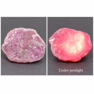 May include: A raw, textured, purplish-pink gemstone shown in two states. The left side displays the stone in natural light, while the right side shows the same stone illuminated by a penlight, revealing a bright, translucent red glow.