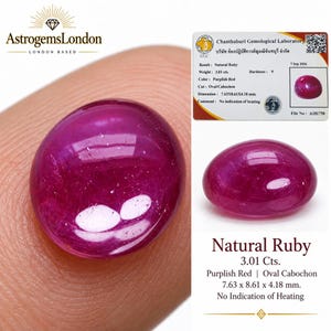 May include: A purplish-red natural ruby with an oval cabochon cut. The gemstone weighs 3.01 carats and measures 7.63 x 8.61 x 4.18 mm. A gemological laboratory certificate accompanies the stone, confirming no indication of heating.