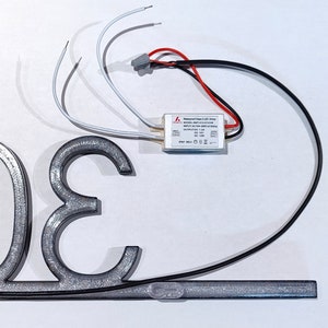 Power configuration for hardwiring a sign to 120 V AC