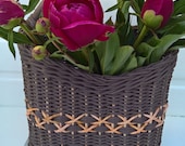Wicker door basket made of paper vine with a wooden handle.Basket for wall or fronthome decoration.Wicker basket for flowers.