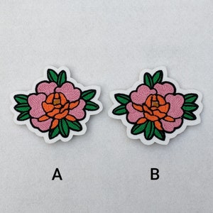 May include: Two embroidered iron-on patches featuring pink and orange peonies with green leaves. The patches are labeled A and B.