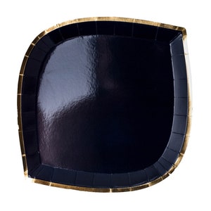 May include: A black paper party plate with a gold rim. The plate is shaped like a leaf and has a glossy finish.