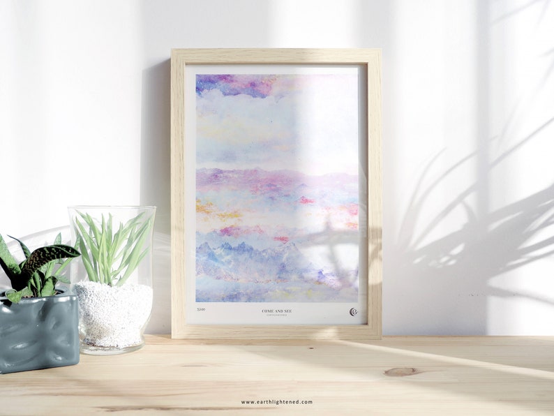 May include: A framed watercolor painting of a colorful landscape with a light blue sky, pink and purple clouds, and blue mountains. The painting is titled "Close and See" and is signed by the artist.
