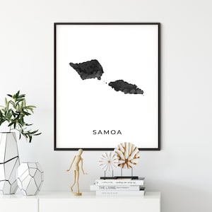 May include: Black and white watercolor print of the islands of Samoa. The print is framed in a black frame and the name "Samoa" is printed in black text below the image.