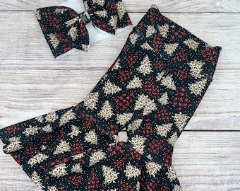 May include: Black and red bell bottom pants with a Christmas tree and plaid pattern. A matching black and red bow with a white center is included.