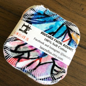 May include: Reusable facial rounds made of 100% soft cotton. The rounds are colorful and feature a geometric pattern. The packaging includes the brand name "LAN CRAFT US" and the text "REUSABLE FACIAL ROUNDS 100% Soft Cotton" and contact information for the seller.
