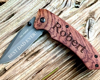 May include: A personalized pocket knife with a wood handle. The handle is engraved with the name "Robert" and the blade is engraved with the text "Best Dad Ever!"