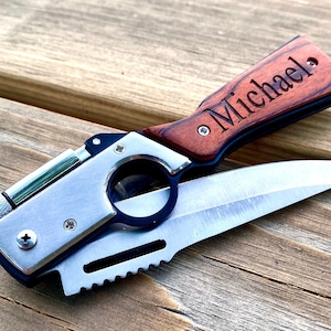 May include: A silver and black pocket knife with a wooden handle engraved with the name "Michael". The knife has a blade, a bottle opener, and a lighter.