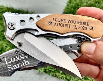 May include: A silver pocket knife with a wooden handle engraved with "I love you more August 12, 2020". The blade is open and the other side of the knife is engraved with "Love, Sarah".