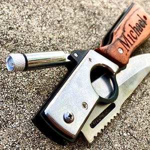 May include: A personalized pocket knife with a wooden handle engraved with the name "Michael". The knife has a silver blade and a built-in flashlight.