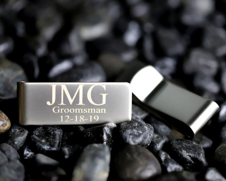 May include: Silver money clip with the initials JMG, the word "Groomsman" and the date "12-18-19" engraved on it.