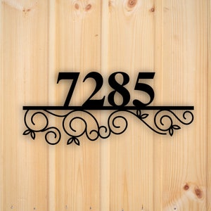 May include: Black metal house number plaque with the number 7285 and a decorative scroll design.