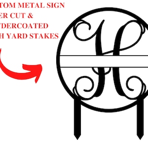 May include: Black metal monogram sign featuring a decorative letter H and a blank space for a name. The sign is attached to two metal stakes for placement in the ground.