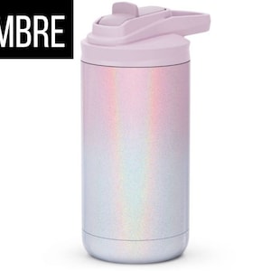 May include: A stainless steel water bottle with a light purple lid and a shimmering, iridescent ombre design. The word "OMBRE" is printed in white on a black rectangle. The bottle has a flip-top lid.