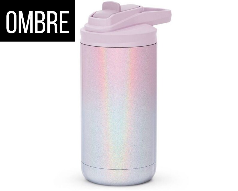 May include: A stainless steel water bottle with a light purple lid and a shimmering, iridescent ombre design. The word "OMBRE" is printed in white on a black rectangle. The bottle has a flip-top lid.