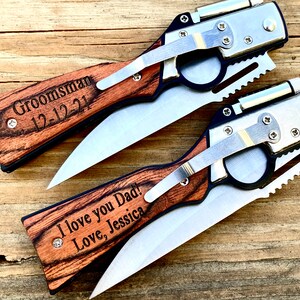 May include: Two personalized pocket knives with wooden handles. The top knife has the text "Groomman 12-12-21" engraved on the handle. The bottom knife has the text "I love you Dad! Love, Jessica" engraved on the handle.