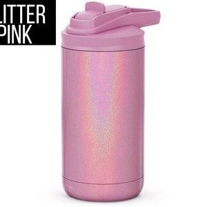 May include: A pink insulated water bottle with a glitter finish. The bottle has a flip-top lid and a handle. The text "GLITTER PINK" is in a black rectangle in the upper left corner. The bottle is designed to keep drinks cold.