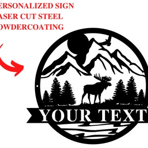 May include: Black metal sign with a mountain scene, a moose, and trees. The sign has a banner at the bottom that says "YOUR TEXT".