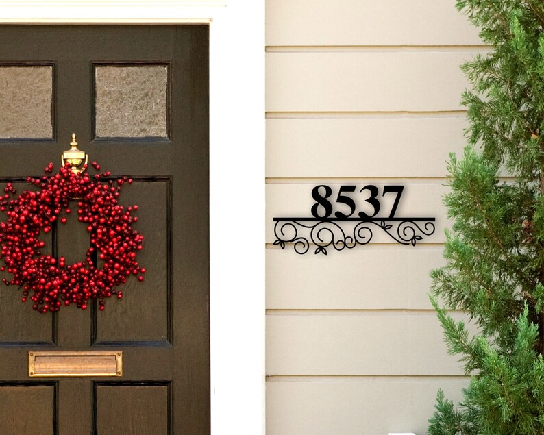 May include: Black metal house number sign with a decorative scroll design. The number 8537 is displayed on the sign.