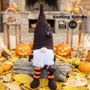 May include: A handmade Halloween gnome with a brown knit hat, white beard, and orange and black striped legs. The gnome holds a broom and has a spider on its hat. The image includes the text "Knitting Pattern".