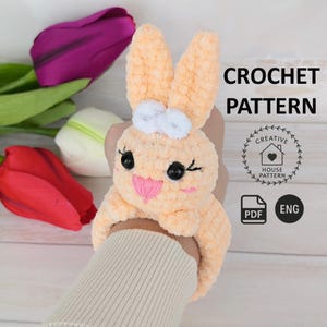 May include: Crochet pattern for a cute orange bunny wristlet. The pattern is available in PDF format and is written in English. The pattern is from Creative House Pattern.