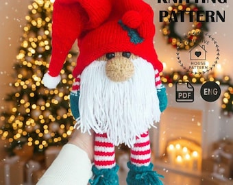 May include: A handmade Christmas gnome doll with a red hat, white beard, and striped legs. The gnome has a tan nose, blue shoes, and green accents. The image includes the text "KNITTING PATTERN".