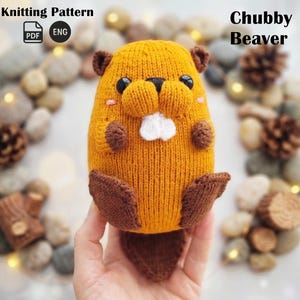 May include: A knitted, plush beaver toy in shades of orange and brown. The beaver has a round body, small ears, and a white tooth. The text "Chubby Beaver" is displayed above the toy. The words "Knitting Pattern" and "PDF ENG" are also visible.