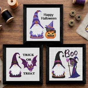 May include: Three framed cross-stitch artworks with Halloween themes. One features a gnome and a pumpkin with a cat, the second says "Trick or Treat" with a bat, and the third says "Boo" with a witch.