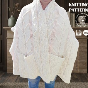May include: Cream-colored knitted poncho with a cable knit design and two front pockets. The poncho has a hood and is labeled as a knitting pattern. The text "KNITTING PATTERN" is visible in the upper right corner.