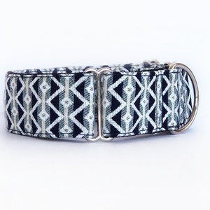 May include: A black and white patterned dog collar with silver hardware.