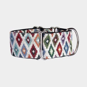 May include: A patterned dog collar featuring a repeating diamond design in various colours including red, green, and blue. The collar has silver metal hardware and a D-ring. The background is a light grey.