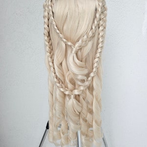 May include: A blonde wig with long, curly hair styled in a braided crown and loose curls cascading down the back.