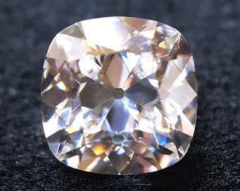 May include: A large, clear, cushion-cut gemstone with a brilliant, faceted surface.
