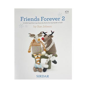 May include: A book cover featuring two knitted reindeer toys sitting on a log. The book title is "Friends Forever 2" and the author is Sue Jobson. The book is published by Sirdar.