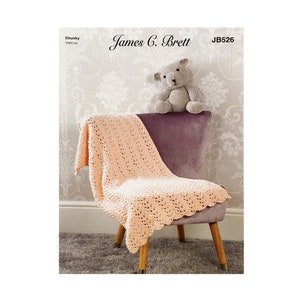 May include: A peach-colored crocheted baby blanket draped over a purple armchair with a gray teddy bear sitting on the back of the chair. The pattern is a simple stitch with a scalloped edge. The chair is on a light brown rug. The text "James C. Brett JB526" is printed on the image.
