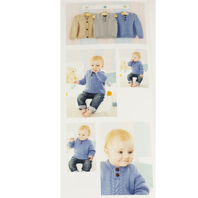 May include: A blue knitted baby sweater with a cable knit pattern and button closure. The sweater is shown on a baby sitting on a white stool. The sweater is also shown on a hanger with two other sweaters, one beige and one light blue.