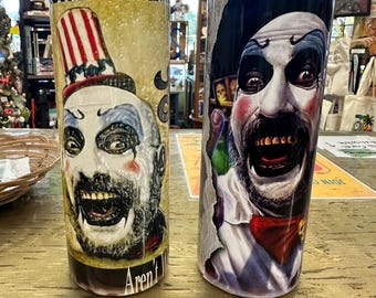 May include: Two stainless steel tumblers with clown-themed designs. One features a clown face with a top hat and the text "You Like Clowns?" and "Aren't I?". The other tumbler has a close-up of a clown face with a red bow tie.