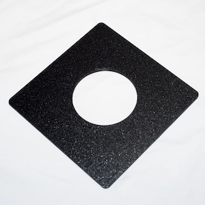 May include: Black square-shaped photographic filter with a round hole in the center.