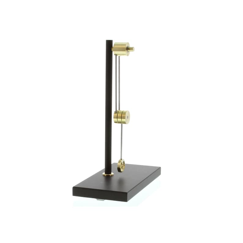 May include: A black wooden base with a black metal rod and a brass pulley system with weights. The weights are attached to a string that runs through the pulley.