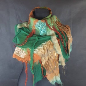 May include: A green, orange, and brown felted scarf with a beaded design. The scarf is draped over a black mannequin.